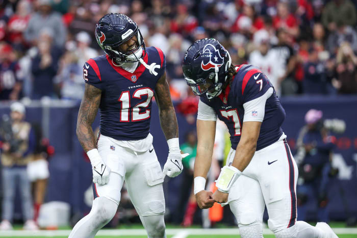 Houston Texans wide receiver Nico Collins (12) celebrates with quarterback C.J. Stroud (7) after a touchdown in a 2024 AFC wild card game against the Cleveland Browns at NRG Stadium.
